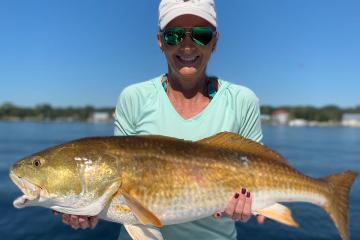 a person holding a fish in the water